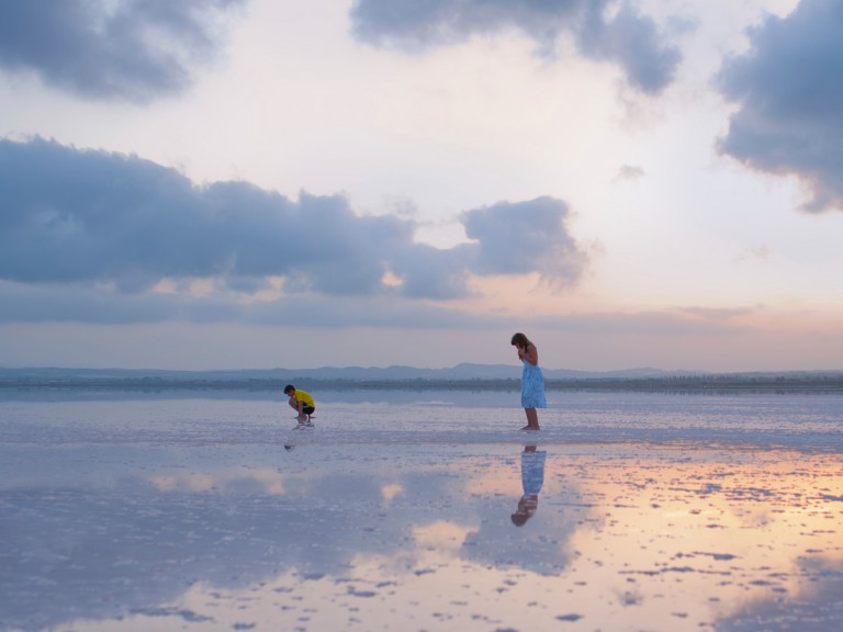 woman and child standing on salt lagoons